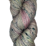 A skein of wool yarn in a light grey color with streaks of pink and dark blue speckles