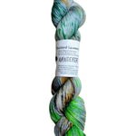 A skein of hand-dyed fingering/sock yarn color grey neon green forest green orange brown black speckles
