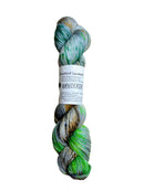A skein of hand-dyed fingering/sock yarn color grey neon green forest green orange brown black speckles