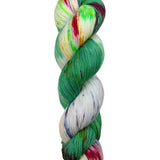 A skein of hand-dyed fingering/sock yarn color white yellow blue green red speckles