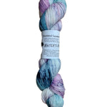 A skein of hand-dyed fingering/sock yarn color pastel pink blue purple navy speckles
