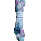 A skein of hand-dyed fingering/sock yarn color pastel pink blue purple navy speckles