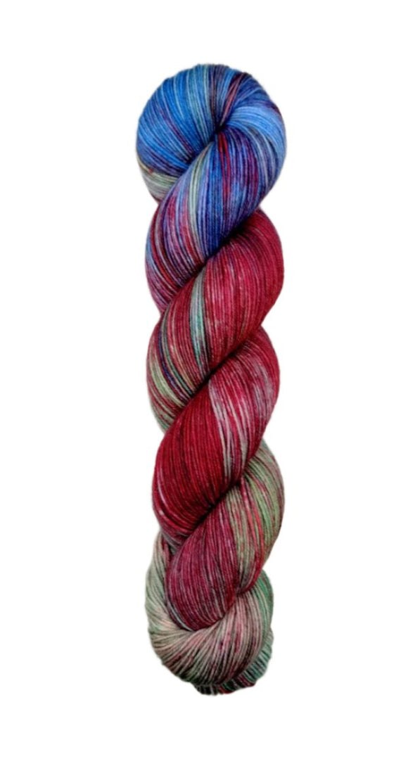 A skein of hand-dyed fingering/sock yarn color brown blue red green purple 