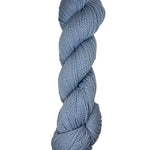 Light blue skein of mountain meadow wool yarn on a white background