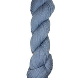 Light blue skein of mountain meadow wool yarn on a white background