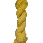 Yellow skein of mountain meadow wool yarn on a white background