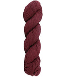 Burgundy skein of mountain meadow wool yarn on a white background