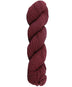 Burgundy skein of mountain meadow wool yarn on a white background