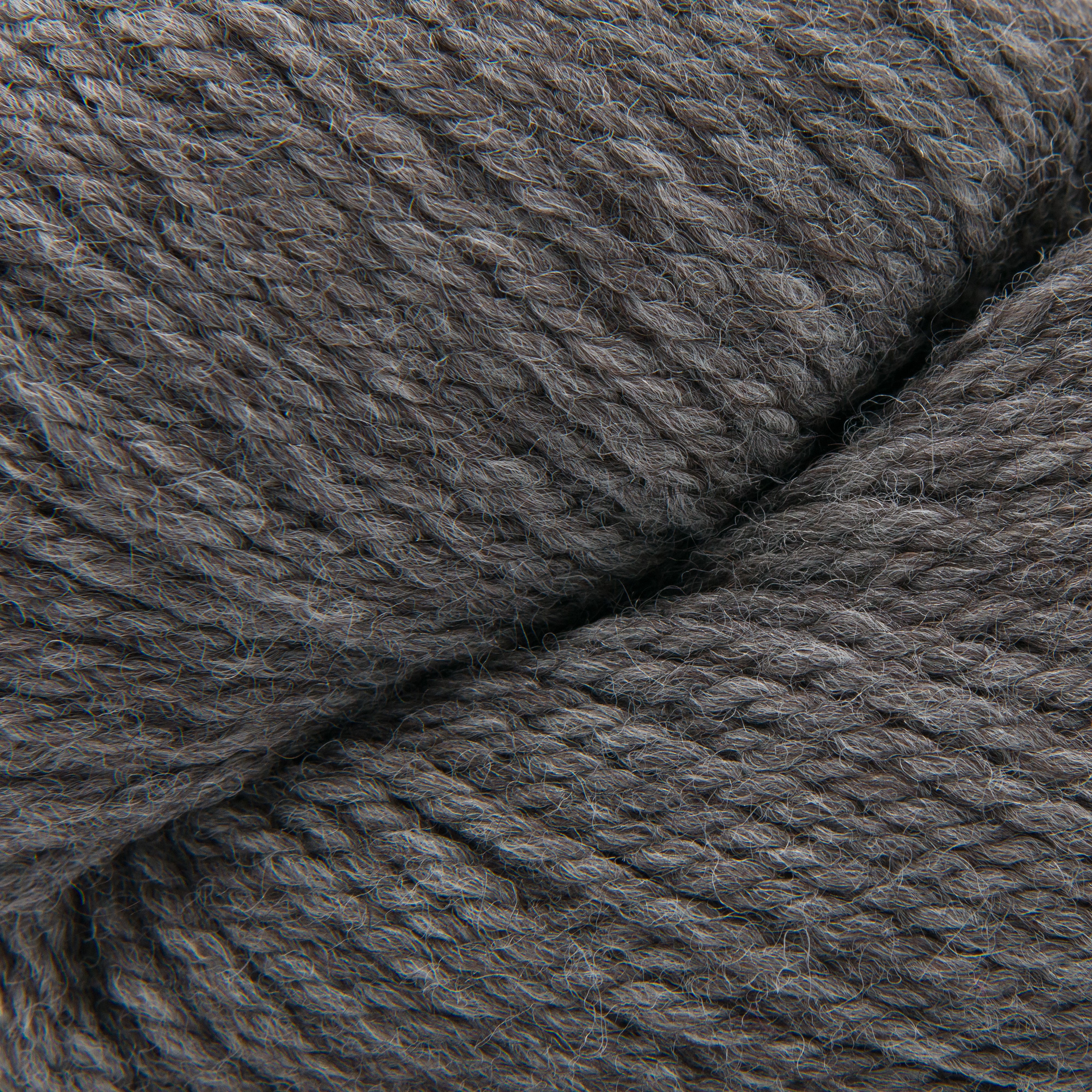 A close-up of dark gray plied yarn with a soft, heathered texture.