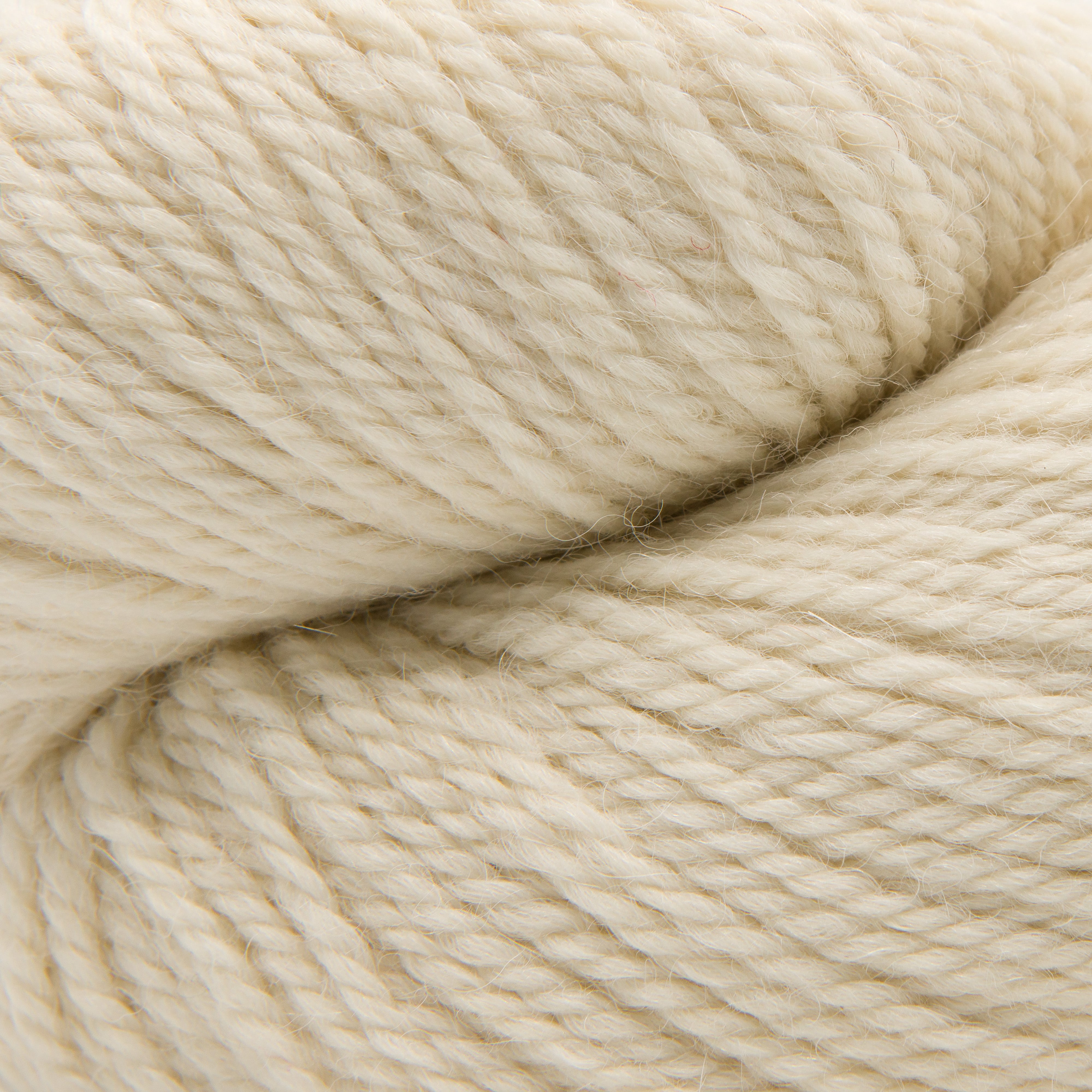 A close-up of cream-colored yarn with a soft, twisted texture filling the frame.