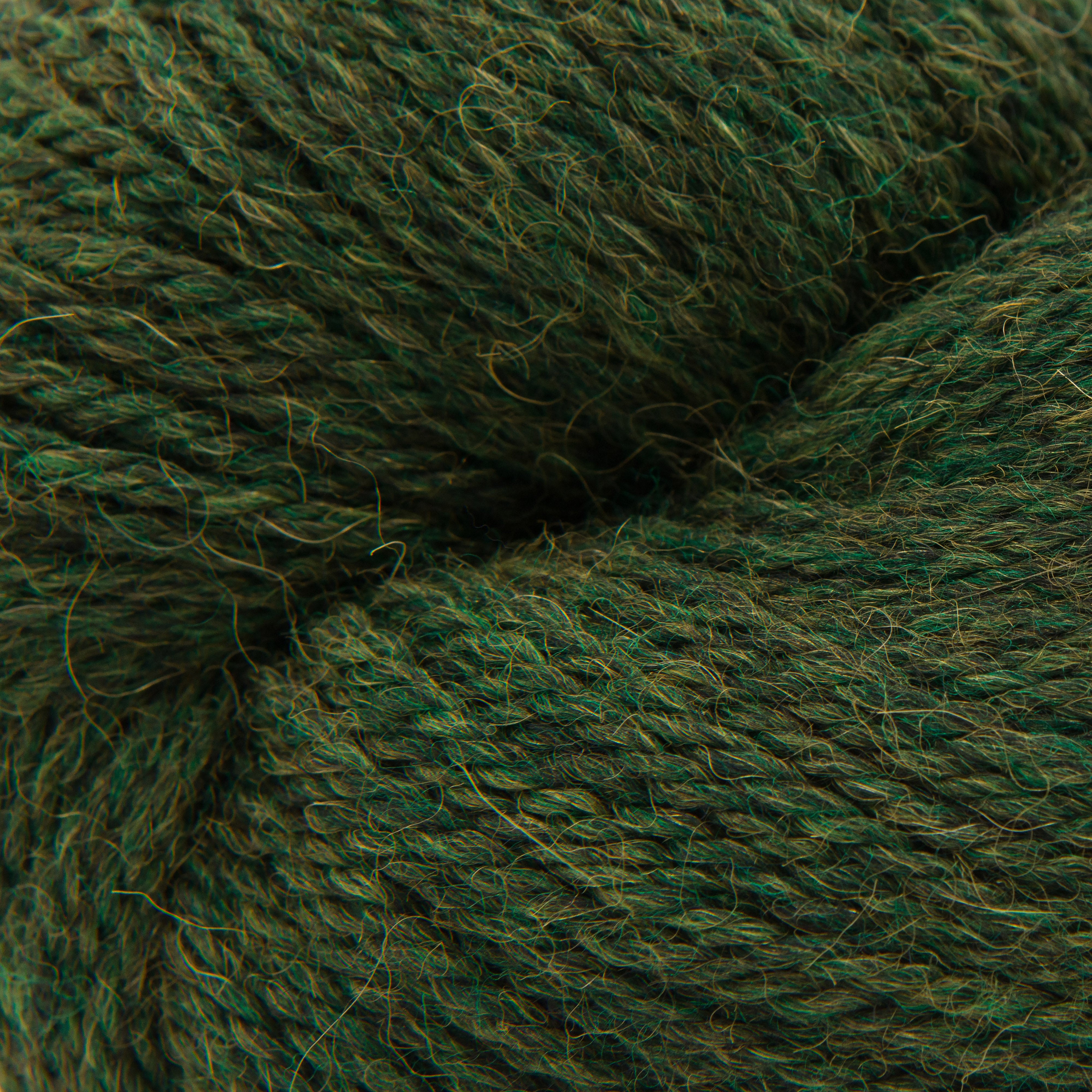 Close-up of dark green yarn texture