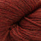 A close-up of thick, twisted yarn in a rich rust red color, showing the fuzzy texture of the fibers.