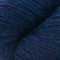A close-up of textured yarn with a variegated colorway of deep navy, purple, and bright teal blue.