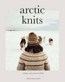 Book cover of 'Arctic Knits' featuring a person in knitted clothing with dogs in a snowy landscape.