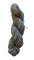 A twisted skein of variegated yarn in muted earthy tones of gray, beige, brown, and hints of blue and purple, photographed on a plain off-white background.