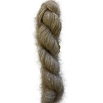 A twisted hank of fuzzy, soft yarn in a warm taupe-gray color, photographed vertically against a plain off-white background.
