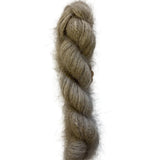 A twisted hank of fuzzy, soft yarn in a warm taupe-gray color, photographed vertically against a plain off-white background.
