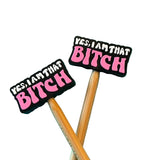Two stitch stoppers with 'YES, I AM THAT BITCH' text in pink