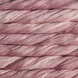 A close-up of twisted yarn or thread strands in a dusty mauve-pink color with subtle tonal variation.