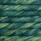 Close-up of twisted yarn skeins in a variegated blend of deep teal, forest green, and soft sage green.