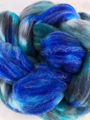 a braid of ready to be spun fiber color teal blue