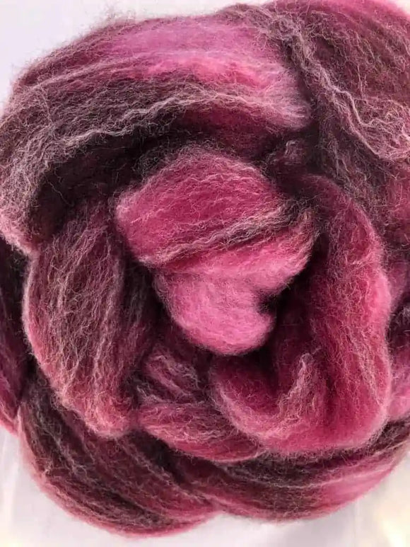 a braid of ready to be spun fiber color red magenta