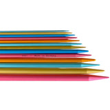 Set of colorful knitting needles on a white background