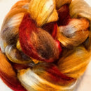 a braid of ready to be spun fiber color orange, red