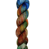 Multicolored skein of yarn on a light wooden surface