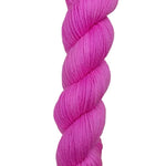 A skein of hand-dyed fingering/sock yarn color pink