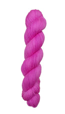 A skein of hand-dyed fingering/sock yarn color pink