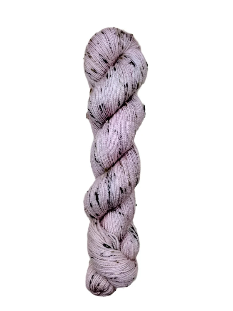 Skein of hand dyed BFL Tweed Yarn color dusty rose