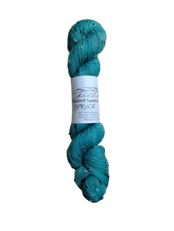 Skein of hand dyed BFL Tweed Yarn color spruce green