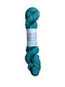 Skein of hand dyed BFL Tweed Yarn color spruce green