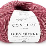 Ball of light red yarn with a 'Concept by Katia' label on a white background