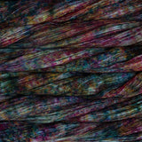 close up view of malabrigo silkpaca lace weight yarn color red teal yellow purple speckles