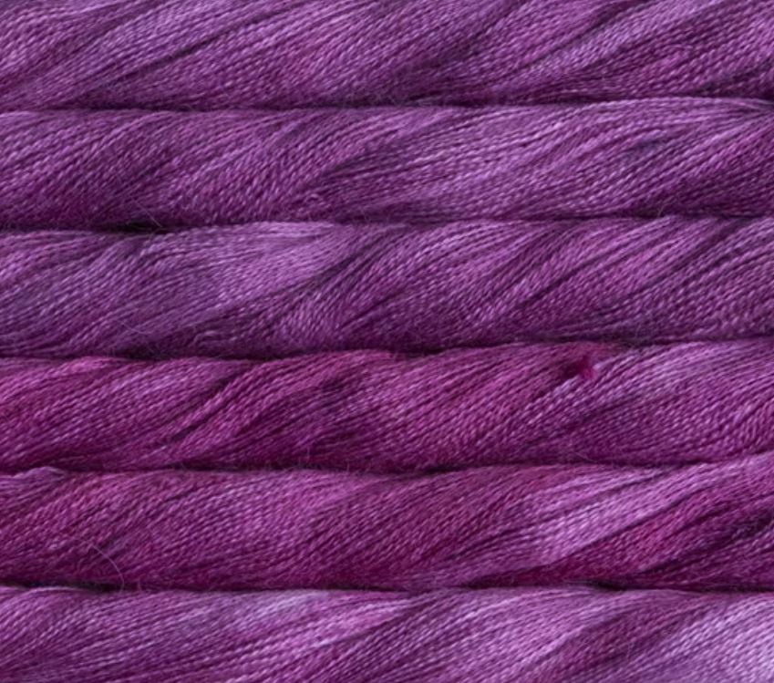 close up view of malabrigo silkpaca lace weight yarn color magenta