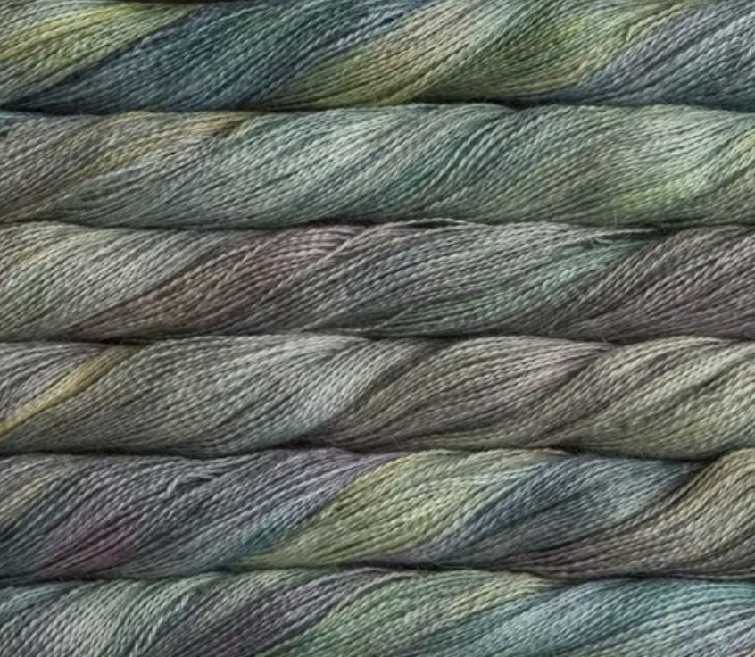 close up view of malabrigo silkpaca lace weight yarn color yellow grey blue light purple