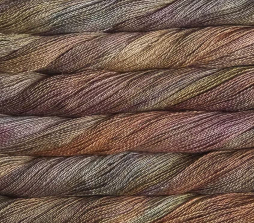 close up view of malabrigo silkpaca lace weight yarn color yellow brown orange green burgundy