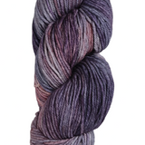 a skein of wool yarn in the color grey denim purple and coral