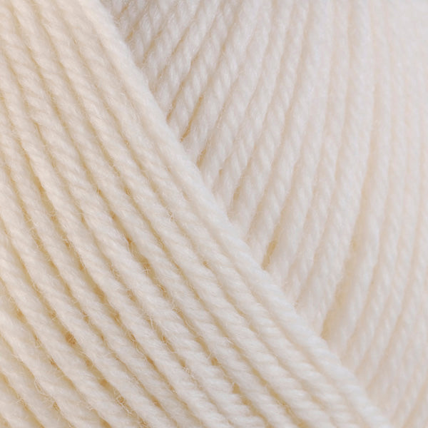 Detailed view of a skein of superwash wool yarn, showcasing a white hue.