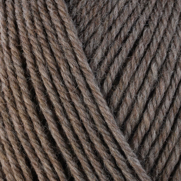 Detailed view of a skein of superwash wool yarn, showcasing a brown hue.