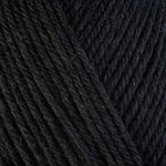 Detailed view of a skein of superwash wool yarn, showcasing a black hue.