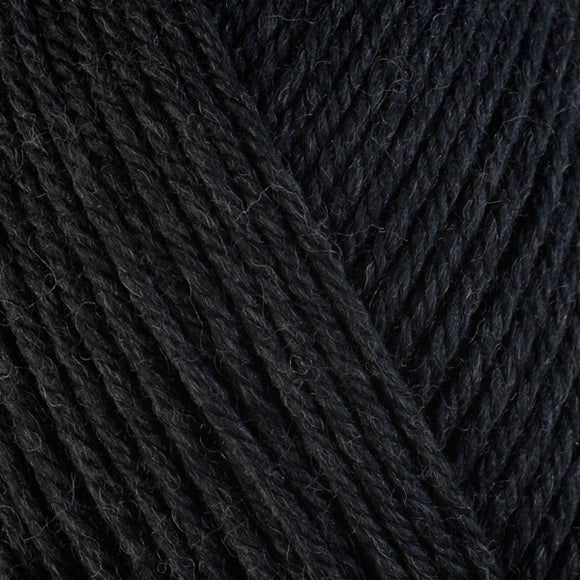 Detailed view of a skein of superwash wool yarn, showcasing a black hue.