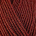Detailed view of a skein of superwash wool yarn, showcasing a rust hue.