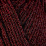Detailed view of a skein of superwash wool yarn, showcasing a deep red hue.