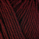 Detailed view of a skein of superwash wool yarn, showcasing a deep red hue.