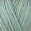 Detailed view of a skein of superwash wool yarn, showcasing a green hue.