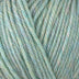 Detailed view of a skein of superwash wool yarn, showcasing a green hue.