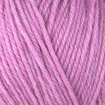 Detailed view of a skein of superwash wool yarn, showcasing a pink hue.